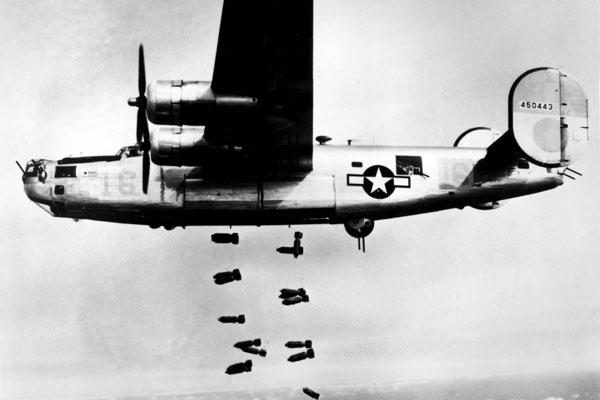 A consolidated B-24 Liberator of the 15th A.F. releases its bombs on the railyards at Muhldorf, Germany on 19 March 1945. (U.S. Air Force photo)