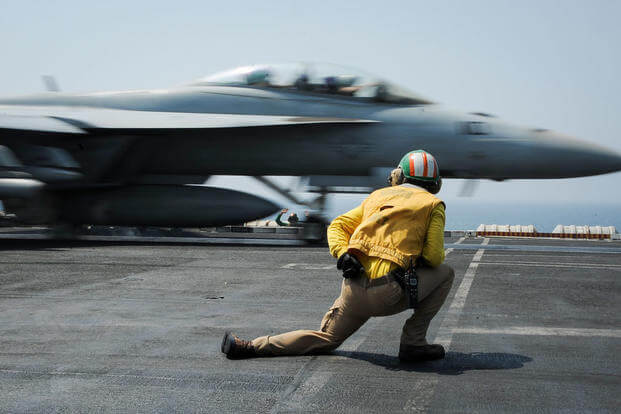 Lt. Cmdr. Craig Ryan launches an F/A-18F Super Hornet assigned to the Red Rippers of Strike Fighter Squadron 11 from the flight deck of the aircraft carrier USS Theodore Roosevelt. (Photo by Mass Communication Specialist 3rd Class Anna Van Nuys)