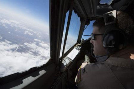 U.S. Air Force Capt. Christopher K. Jordan, 968th Expeditionary Airborne Air Control Squadron E-3/B Sentry aircraft commander, scans the horizon while flying a combat sortie supporting coalition forces during the Afghan Presidential Elections, April 5.