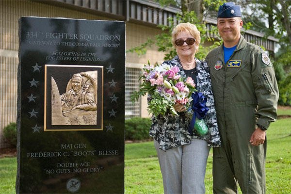 Betty Blesse, wife of retired Maj. Gen. Frederick “Boots” Blesse, stands with Lt. Col. Donn Yates after the unveiling of her late husband’s monument during a memorial dedication ceremony, June 27, 2014, on Seymour Johnson Air Force Base, N.C. 