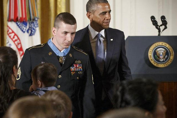 President Barack Obama and Medal of Honor recipient, Sgt. Ryan M. Pitts, 28, leave the stage in the East Room of the White House after a ceremony marking Pitts' valor in Afghanistan, Monday, July 21, 2014. AP Photo/J. Scott Applewhite)