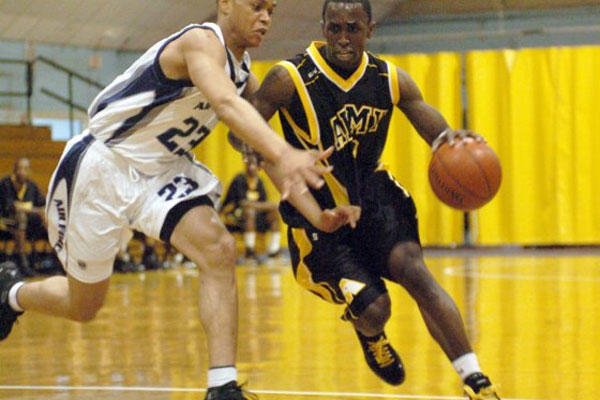 Army Staff Sgt. Ronald Bartley drives past Air Force Senior Airman Ollie Bradley during the 2008 Armed Forces Basketball Championships at Fort Indiantown Gap, Pa. (U.S. Army photo by Tim Hipps)
