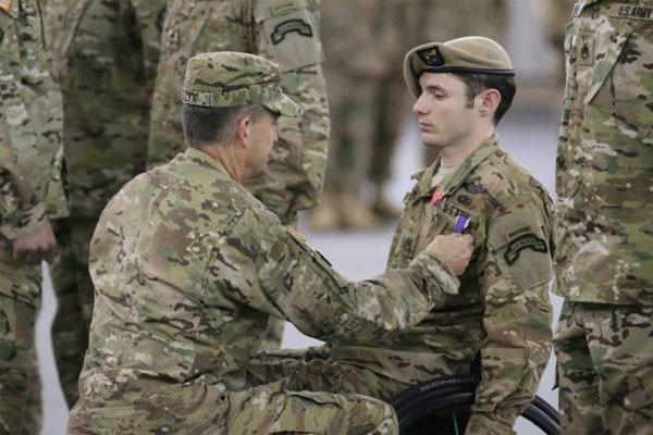 Gen. Daniel B. Allyn, Army vice chief of staff, presents Staff Sgt. Travis D. Dunn, Bravo Company, 1st Battalion, 75th Ranger Regiment, with the Bronze Star with Valor and a Purple Heart, April 29, 2015.(U.S. Army photo/ Pfc. Eric Overfelt)