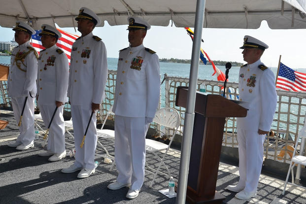 Coast Guard Cmdr. Craig J. Wieschhorster and Cmdr. Adam B. Morrison stand at attention during the change of command ceremony for the Coast Guard Cutter Mohawk in Key West, Fla., July 2, 2015. (U.S. Coast Guard photo)
