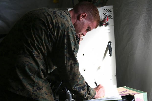 Lance Cpl. Joseph Connelly writes down the locations of each company at the Boondocker Training Area aboard Marine Corps Base Hawaii during training exercise Island Viper, Sept. 22, 2015. Photo By: Lance Cpl. Harley Thomas
