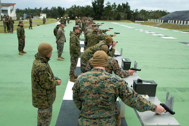 Shooters fire pistols during the Far East Division Marksmanship Match Dec. 17 aboard Camp Hansen, Okinawa, Japan. (Photo: Lance Cpl. Doug Simons)