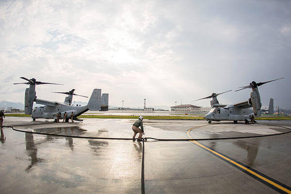 Marines with Marine Aerial Refueler Transport Squadron (VMGR) 152 MV-22B Osprey tiltrotor aircrafts during air delivery ground refueling training. (Cpl. Carlos Cruz Jr./U.S. Marine Corps)