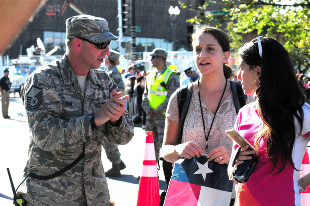 Master Sgt. Robert Hook, 113th Wing, D.C. Air National Guard, gives directions to an attendee at the 2015 Papal Visit in Washington, D.C., Sept. 23. (Air National Guard photo by Erica Rodriguez)