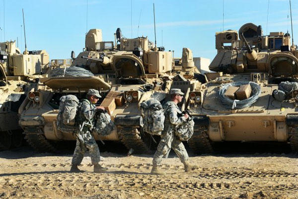 Soldiers of 1st Armored Brigade Combat Team, 1st Cavalry Division carry bags to vehicles during a final preparation in advance of "roll out" to the training area at the National Training Center at Fort Irwin, Calif., Oct. 8. (Photo: Mr. Gustavo Bahena)