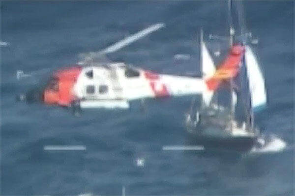 The Coast Guard hoists a man Tuesday, Dec. 15, 2015, after his sailboat became disabled approximately 60 miles off Cape Lookout, North Carolina. (U.S. Coast Guard video by Air Station Elizabeth City, North Carolina)