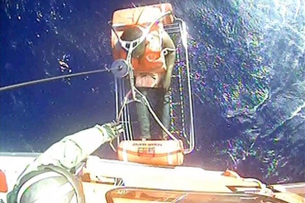 A Coast Guard helicopter rescues one of twelve crewmembers who abandoned ship in Cuban territorial seas Dec. 26, 2015. (U.S. Coast Guard)