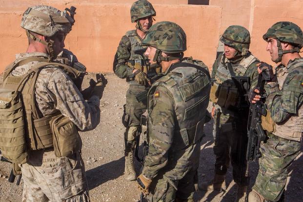 U.S. Marines with Special-Purpose Marine Air-Ground Task Force Crisis Response-Africa discuss lessons learned with Spanish Legionnaires during a military operations in urban terrain exercise, Dec. 15. (Photo: Staff Sgt. Vitaliy Rusavskiy)