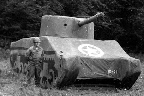   A Ghost Army soldier with an inflatable M4 Sherman Tank, September 1944, France. (National Archives) 