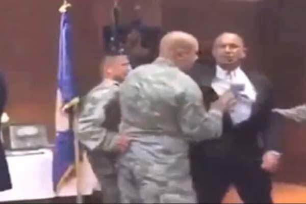 Video captures a retired U.S. Air Force sergeant being forcibly removed from a ceremony at Travis Air Force Base (Video Still)