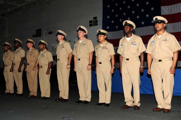 Nine newly frocked senior chief petty officers aboard USS GEORGE H.W. BUSH (CVN 77) are presented to the crew during a pinning ceremony in the ship's hangar bay. (U.S. Navy/Mass Communication Specialist 3rd Class Brent Thacker)