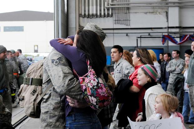 FILE --  An Airman greets his wife as family members rush to find their loved ones during a celebration for those returning home Feb. 5, 2010. (U.S. Air Force/Airman 1st Class Staci Miller)