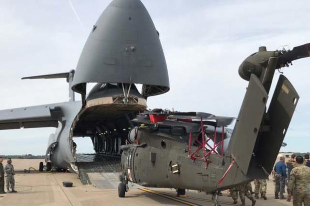 Soldiers with the 101st Combat Aviation Brigade, 101st Airborne Division (Air Assault) and Airmen with the 68th Airlift Squadron, 433rd Airlift Wing prepare an HH-60 medevac Blackhawk, Sept. 10, to load into a C-5M Super Galaxy. (Photo: U.S. Army)