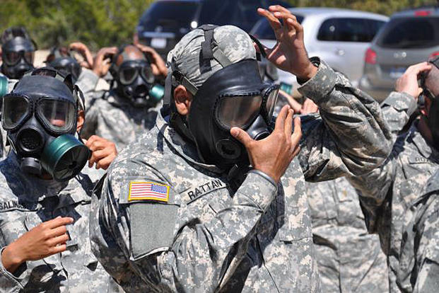 Capt. (Dr.) Tejdeep Singh Rattan, a Sikh dentist serving in the U.S. Army, checks the seal on his gas mask before entering the gas chamber during nuclear, biological and chemical training in 2010. Steve Elliott/Army
