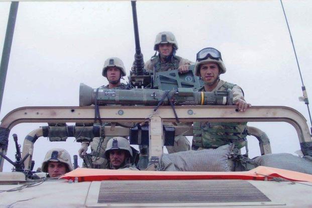 Jeffrey Carisalez, right, then a lance corporal and vehicle mechanic for Bravo Company, shown in a Humvee with fellow Marines in Iraq in 2003. (Photo courtesy Jeffrey Carisalez)
