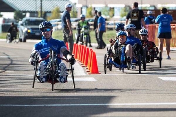 Former Senior Airman Jeremiah Means crosses the finish line at the Warrior Games hand-cycling event Sept. 29, 2014, at Fort Carson, Colo. He took 8th place in his category. Senior Airman Jette Carr/Air Force