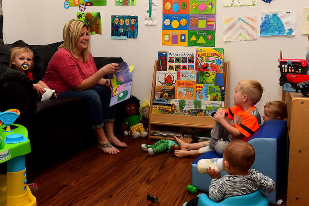 Kathryn Barrager, Child Development Center family child care provider, reads to the children at Joint Base Langley-Eustis, Virginia. (Photo: U.S. Air Force/Senior Airman Derek Seifert)
