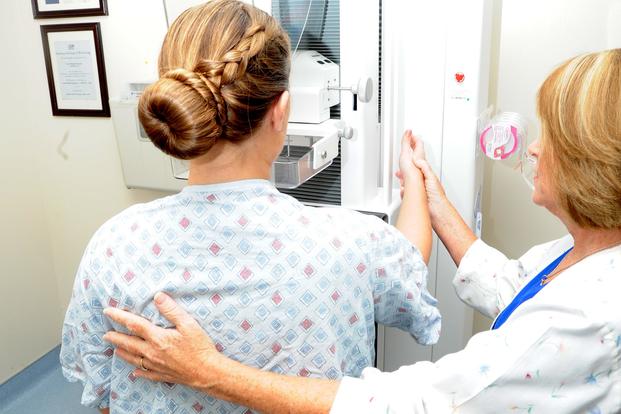 Deborah Vanloh, a mammogram technologist at Naval Hospital Pensacola, prepares a patient for a mammogram Oct. 5, 2015. Photo by Jason Bortz/Navy