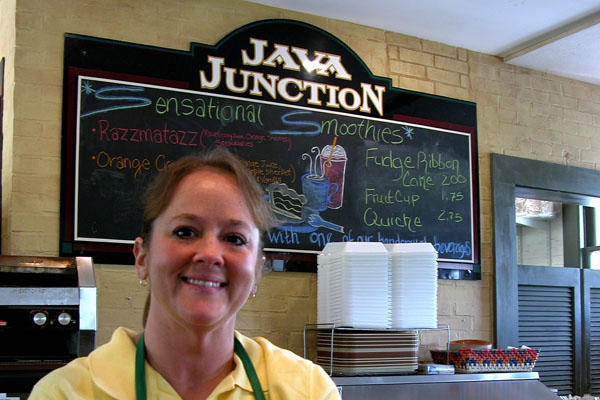 Lisa Rowe smiling at the Java Junction coffee shop she operates.