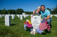 Alison Malachowski and former Marine Sgt. Danny Gonzalez hold each other at the grave marker of U.S. Marine Corps Staff Sgt. James Malachowski - Alison's son and Gonzalez's best friend and fellow Marine - in Section 60 of Arlington National Cemetery, July 22, 2015. (U.S. Army/Ken Scar)