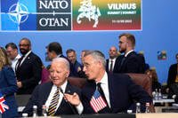 NATO Secretary General Jens Stoltenberg speaks with U.S. President Joe Biden during a meeting of the NATO-Ukraine Council during a NATO summit in Vilnius, Lithuania.