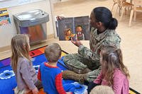 U.S. Air Force Major Avante Graves, 14th Comptroller Squadron commander reads to children at the Child Development Center at Columbus Air Force Base
