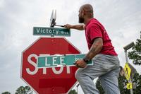 Christian Maynor replaces the Lee Boulevard street sign at Joint Base Langley-Eustis, Virginia.