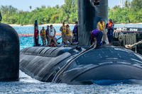 NAVAL BASE GUAM (April 14, 2025) Sailors assigned to the Virginia-class fast-attack submarine USS Minnesota (SSN 783) prepares to moor alongside the submarine tender USS Emory S. Land (AS 39) onboard Naval Base Guam, April 14, 2025. Minnesota returns to its homeport following its first operational tasking while forward-deployed in the Indo-Pacific region. Assigned to Commander, Submarine Squadron 15, based at Polaris Point, Naval Base Guam, Minnesota is one of five forward-deployed fast-attack submarines. Renowned for their unparalleled speed, endurance, stealth, and mobility, fast-attack submarines are the backbone of the Navy’s submarine force. Regarded as apex predators of the sea, Guam’s fast-attack submarines serve at the tip of the spear, helping to reaffirm the submarine force's forward-deployed presence in support of a free and open Indo-Pacific (U.S. Navy photo by Lt. James Caliva).