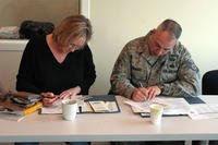 airman and spouse fill out paperwork