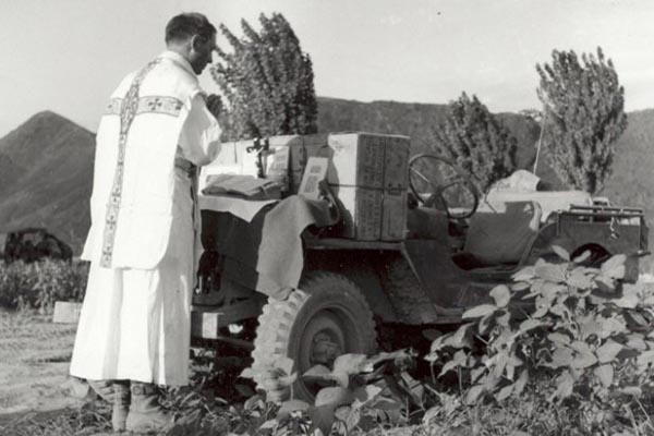 Army Chaplain Fr. Emil Kapaun is seen in this Army photo conducting Roman Catholic Mass, using the back of a jeep for an altar. US Army photo