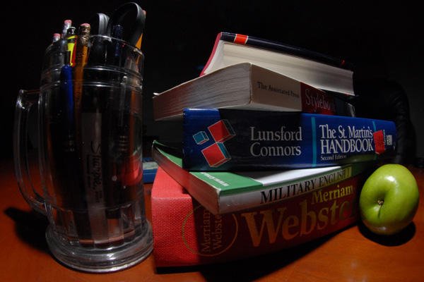 Stack of textbooks with apple