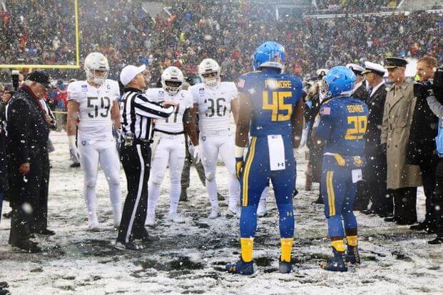 Secretary of State Rex Tillerson oversees the coin flip between the captains of the two teams at midfield before kickoff. (Photo by Steve Whitman/Military.com)