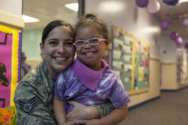 Staff Sgt. Yinell Covington, and her daughter, Maya Rosario, pose for a picture at a school parade at the Joint Base Andrews Child Development Center. (U.S. Air Force/Rustie Kramer)