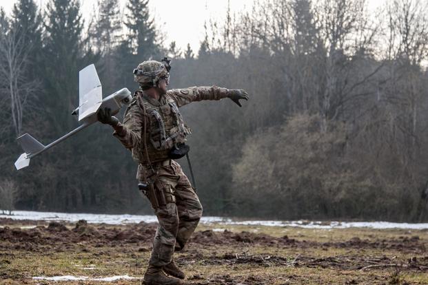 Spc. William Ritter, a military policeman with 287th Military Police Company, 97th Military Police Battalion, 89th Military Police Brigade, Fort Riley, Kansas, prepares to launch the RQ-11 Raven, small unmanned aerial system (SUAS), into the air during Allied Spirit VIII at Hohenfels, Germany, Jan. 26, 2018. (Dustin D. Biven/U.S. Army)