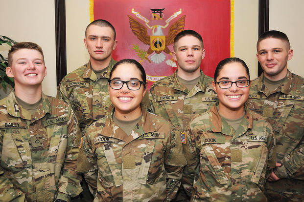 Pvts. Haley and Ashley Cook (front row); Pfc. Nicolette Bailey and her brother Pvt. James Dongarra; and Pvts. Andrew and Jacob Strength pose for pictures at the 16th Ordnance Battalion headquarters Nov. 16. The Soldiers -- the females are assigned to Alpha Company and the males to Charlie -- are all undergoing training in the Wheel Vehicle Mechanic Course at the Ordnance School. (U.S. Army/Terrance Bell)