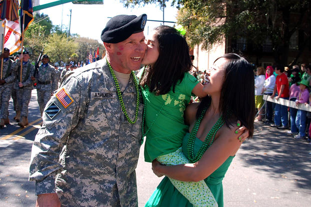 The 3rd Infantry Division's Command Sgt. Maj. Jeffrey Ashmen gets a kiss during the St. Patrick's Day parade in Savannah on March 17, 2011. (US Army photo/Monica Smith)