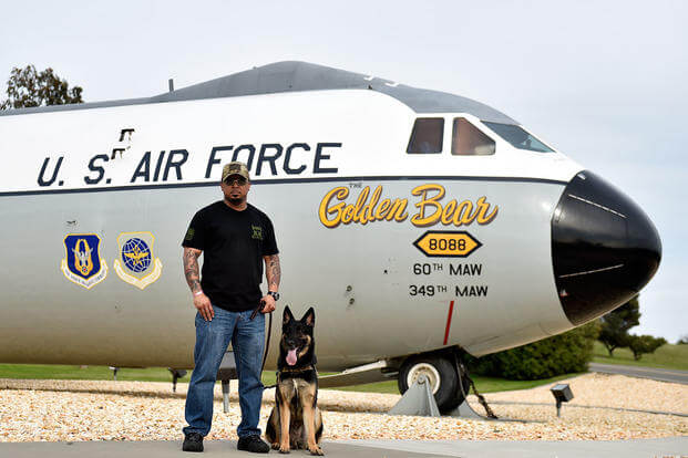 Retired Tech. Sgt. Brandon Jones and his service dog, Apache, pose for a photograph at Travis Air Force Base, Calif., Mar. 30, 2018. (U.S. Air Force photo by Tech. Sgt. Lilliana Moreno)