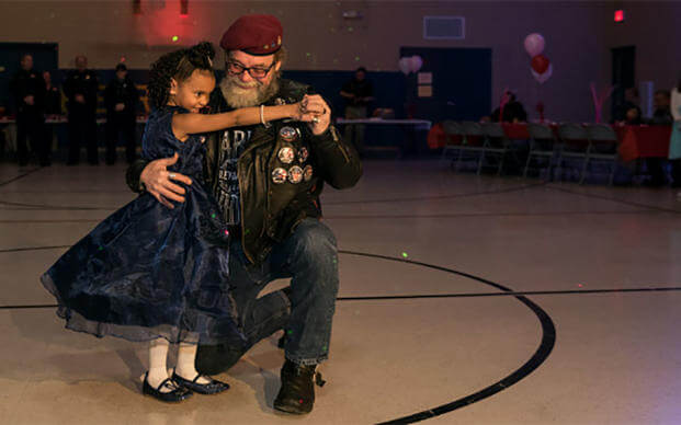 Cayleigh Hinton whose father, Sgt. Terrence Hinton died in a 2017 training accident, dances with David Gier, Senior Ride Captain of the Illinois Patriot Guard, at a father-daughter dance. (Illinois National Guard/Staff Sgt. Robert R. Adams) 