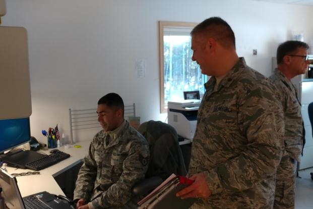 Communication Airman, Staff Sgt. Samuel Camarista and Maj. Brett Ringger work together to ensure the electronic health care records systems are running during ARCTIC CARE 2017 between Kodiak Area Native Association and military IT systems to better support medical providers before seeing patients in Port Lions, Alaska, on March 29, 2017. (U.S. Air Force photo by Tech. Sgt. Wendy Day)