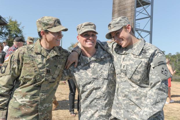 From left, U.S. Army Capt. Kristen Griest, Maj. Lisa Jaster and 1st Lt. Shaye Haver share a moment following Jaster's graduation from Ranger School on Fort Benning, Ga., Oct. 16, 2015. (U.S. Army/Staff Sgt. Alex Manne/ Released)