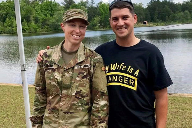 Capt. Natalie Mallue (left) and her husband Capt. Edward Mallue (right) wearing a "My Wife is a Ranger" shirt, pose for a photo after Natalie successfully became the sixth female to graduate Ranger School, Fort Benning, Ga., April 28, 2017. Mallue is also the first female to hold both Ranger and Sapper tabs. (Courtesy Photo)