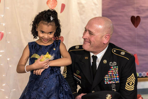 Cayleigh Hinton and Illinois National Guard 1st Sgt. Joseph Bierbrod arrive at a father-daughter dance in February. Cayleigh’s father, Sgt. Terrence Hinton, died in a 2017 training accident. (Illinois National Guard/Staff Sgt. Robert R. Adams)