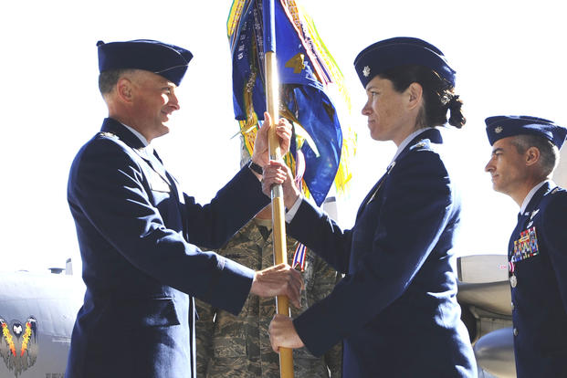 Lt. Col. Brenda Cartier is presented with the guidon to her new squadron during a change-of-command ceremony at Hurlburt Field, Florida, on Feb. 20, 2009. At the time, she became the first female commander of a flying squadron. (US Air Force photo) 