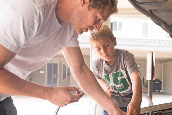 Father and son working on a car
