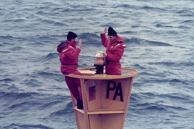 Chief Petty Officer Bob Trainor reenlists on “PA” Lighted Buoy in the Straits of Juan de Fuca, while stationed aboard Coast Guard Cutter Fir (WLM-212) in February 1986. (Photo courtesy of Bob Trainor)