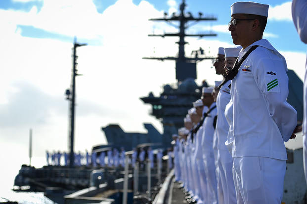 Sailors man the rails aboard the aircraft carrier USS Nimitz (CVN 68) as the ship prepares to moor at Joint Base Pearl Harbor-Hickam, Hawaii, Nov. 21, 2017. (U.S. Navy photo/Cole Schroeder)